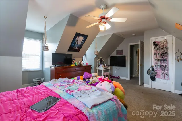 a bedroom with a bed mirror and a window