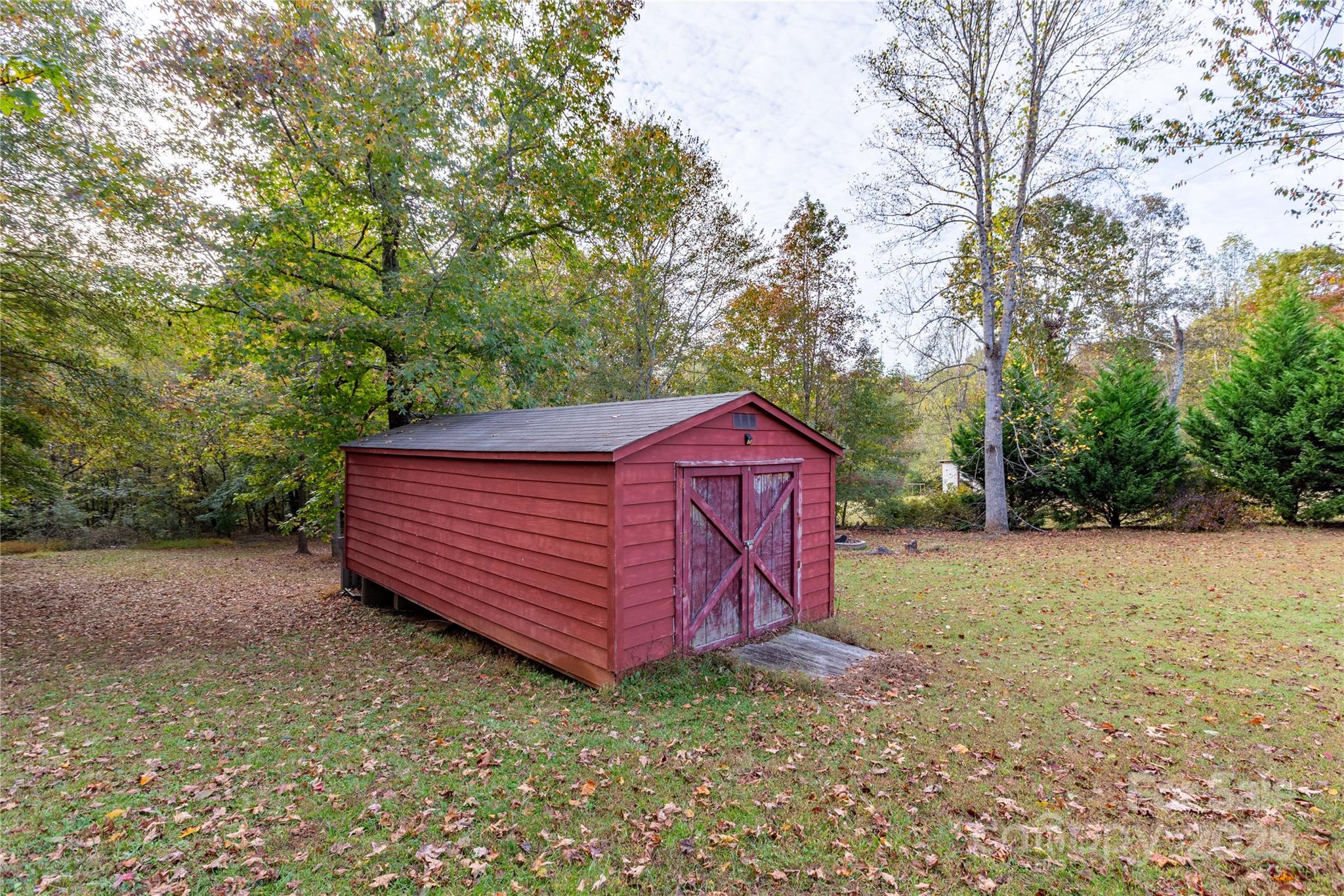 505 Coffeetree Lane Stanley, NC 28164 - Photo 32 of 37 a view of a backyard with large trees and wooden fence