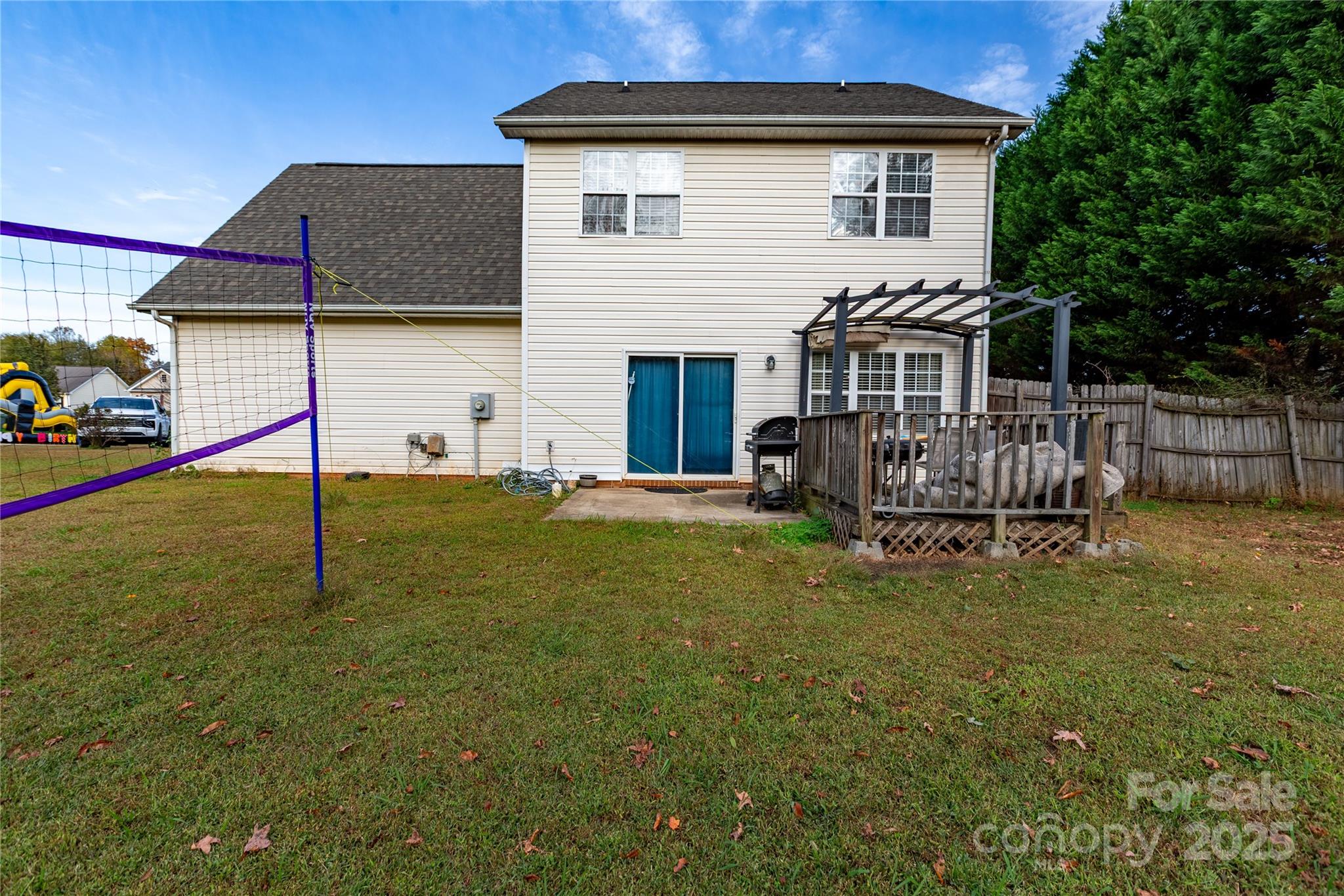 505 Coffeetree Lane Stanley, NC 28164 - Photo 34 of 37 a white house that has a small yard and a wooden fence