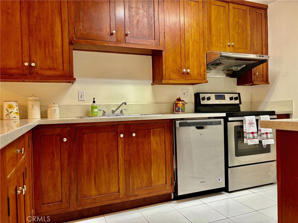 1126 Fairview Avenue, Unit 210 Arcadia, CA 91007 - Photo 5 of 16 a kitchen with stainless steel appliances granite countertop wooden cabinets and a sink