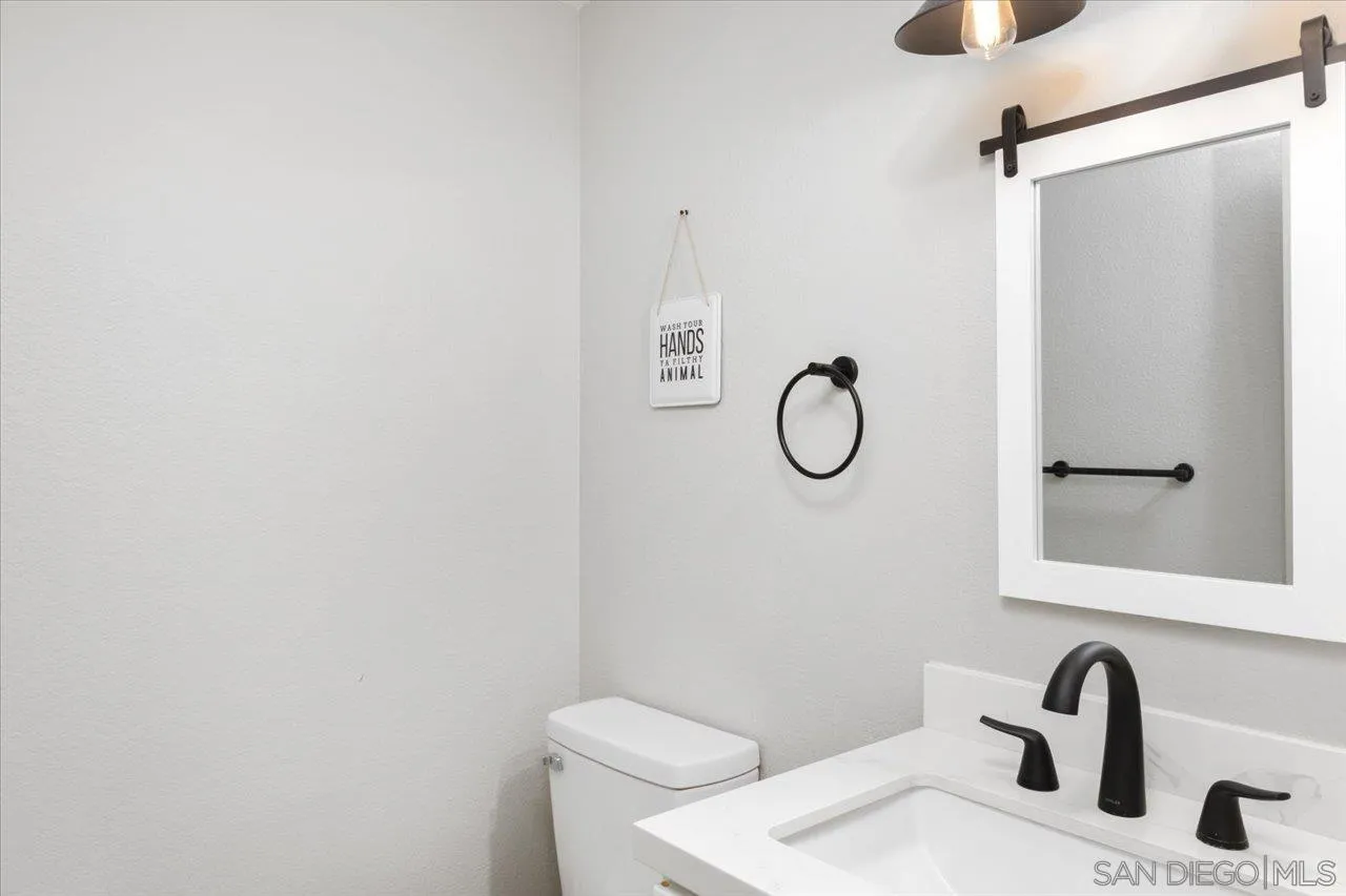 562 Tag Lane Ramona, CA 92065 - Photo 12 of 30 a bathroom with a granite countertop toilet sink and mirror