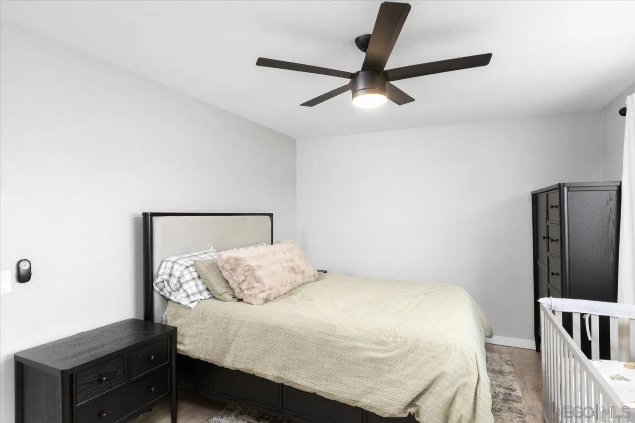 562 Tag Lane Ramona, CA 92065 - Photo 18 of 30 a bedroom with a bed and a chandelier