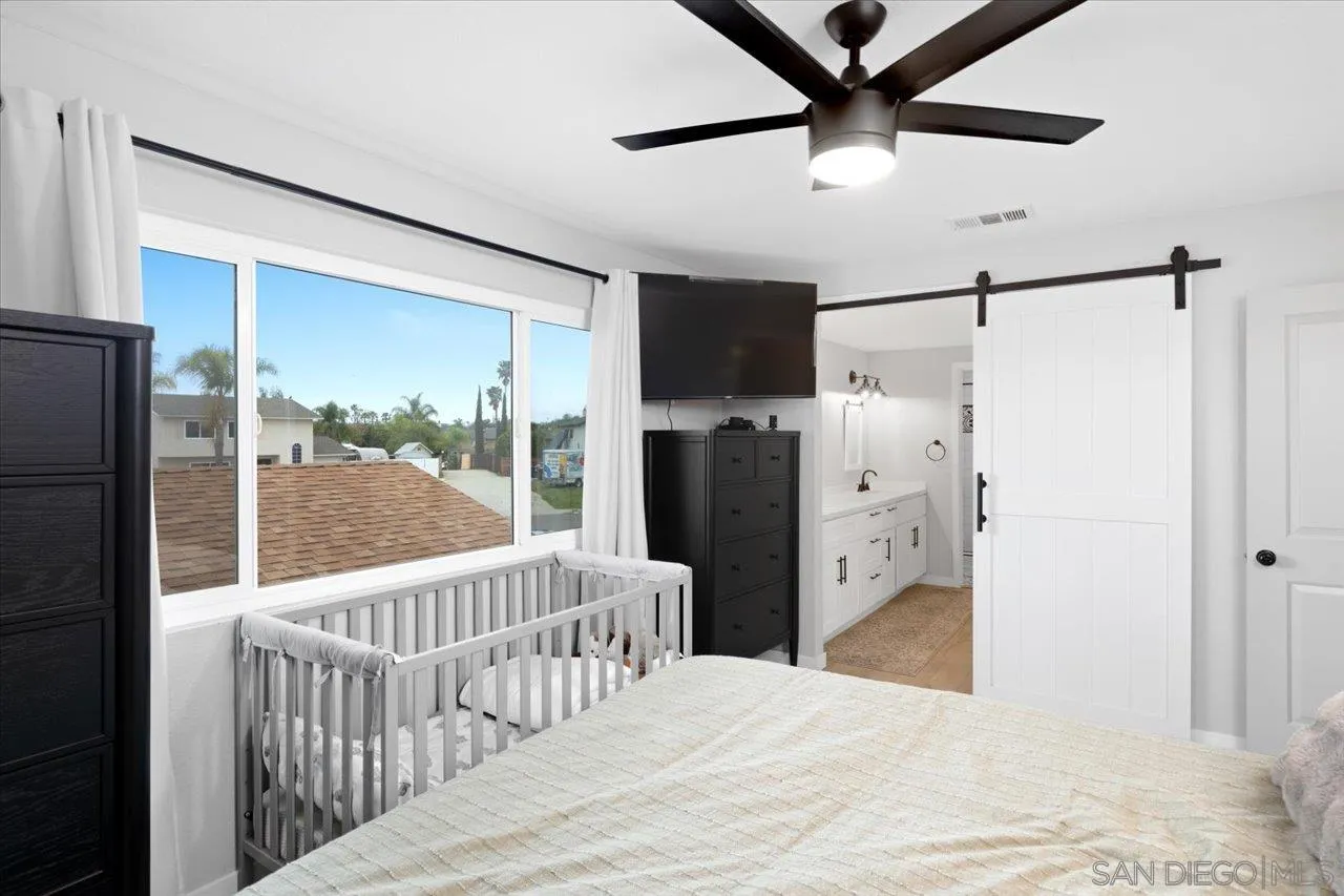 562 Tag Lane Ramona, CA 92065 - Photo 19 of 30 a bedroom with a bed and a large window