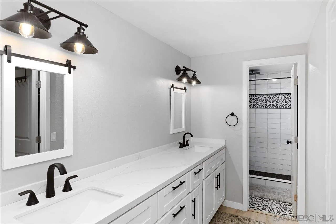 562 Tag Lane Ramona, CA 92065 - Photo 20 of 30 a bathroom with a double vanity sink a mirror and shower
