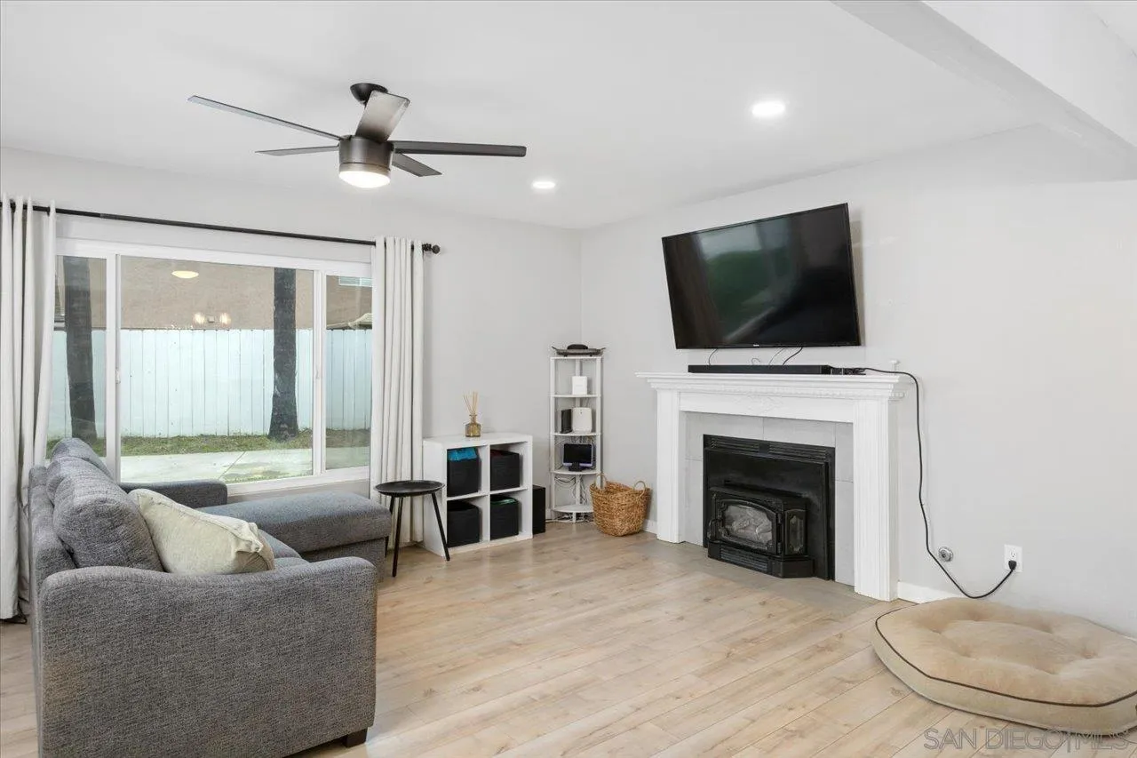 562 Tag Lane Ramona, CA 92065 - Photo 6 of 30 a living room with furniture a fireplace and a flat screen tv