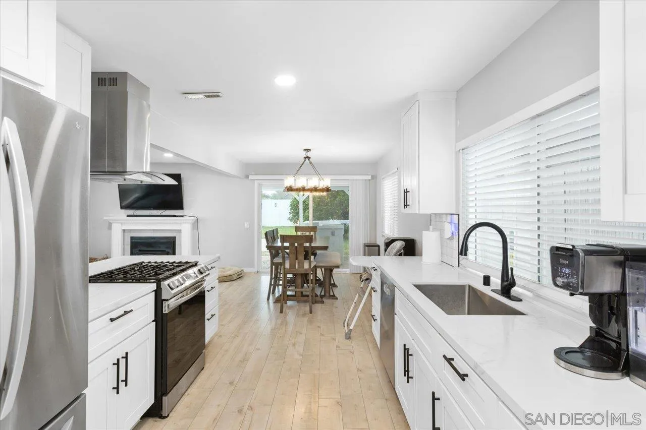 562 Tag Lane Ramona, CA 92065 - Photo 10 of 30 a kitchen with granite countertop a sink a counter space appliances and cabinets