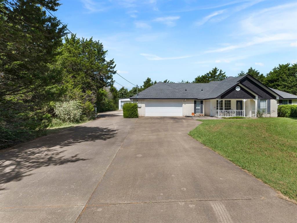 401 Rugged Drive Red Oak, TX 75154 - Photo 6 of 40 Spacious concrete driveway and front yard with mature landscaping