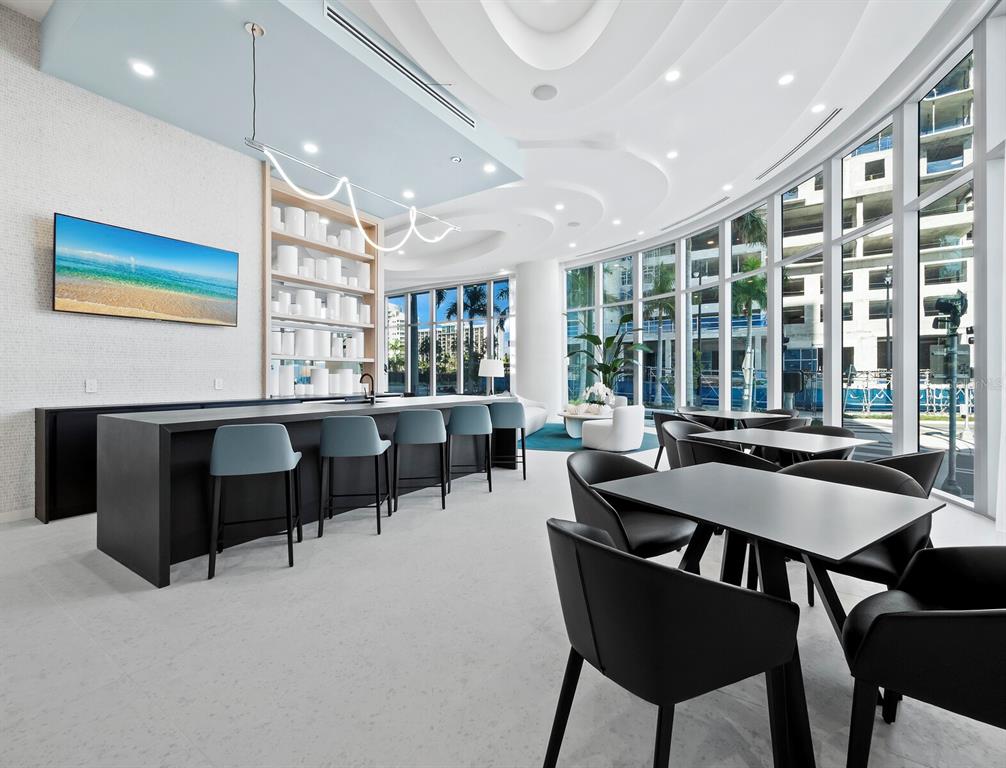 301 Quay Commons, Unit 1409 Sarasota, FL 34236 - Photo 20 of 45 a dining room with furniture and window