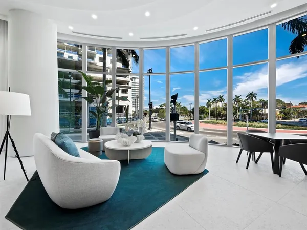 a living room with couches a coffee table and next to a window
