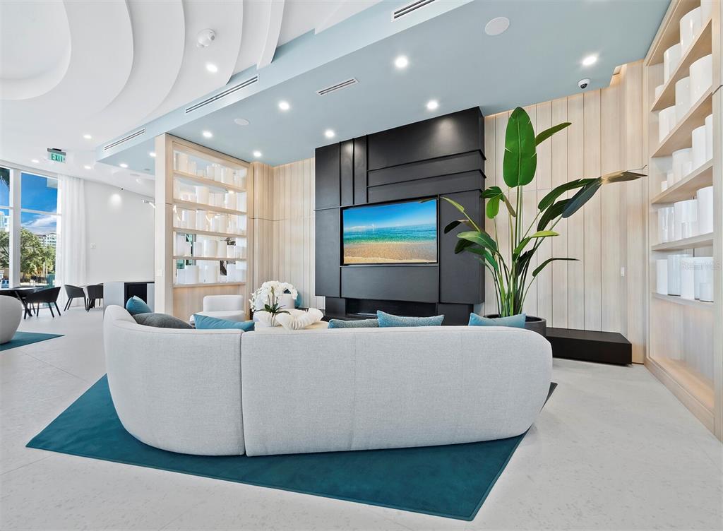 301 Quay Commons, Unit 1409 Sarasota, FL 34236 - Photo 22 of 45 a living room with furniture and a flat screen tv