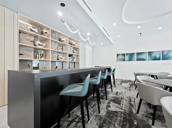a dining room with a table chairs and a kitchen view