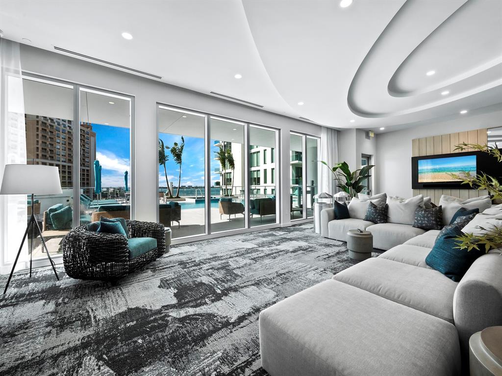 301 Quay Commons, Unit 1409 Sarasota, FL 34236 - Photo 28 of 45 a living room with furniture and a flat screen tv