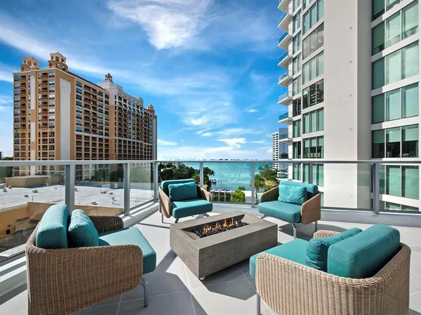 a view of roof deck with couches and potted plant