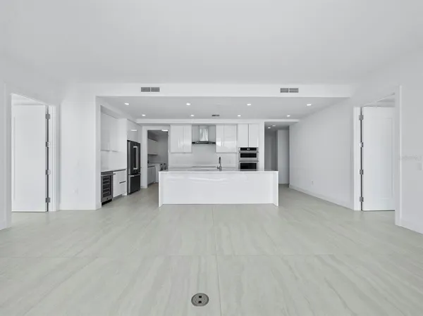 a view of a kitchen with a sink and white cabinets