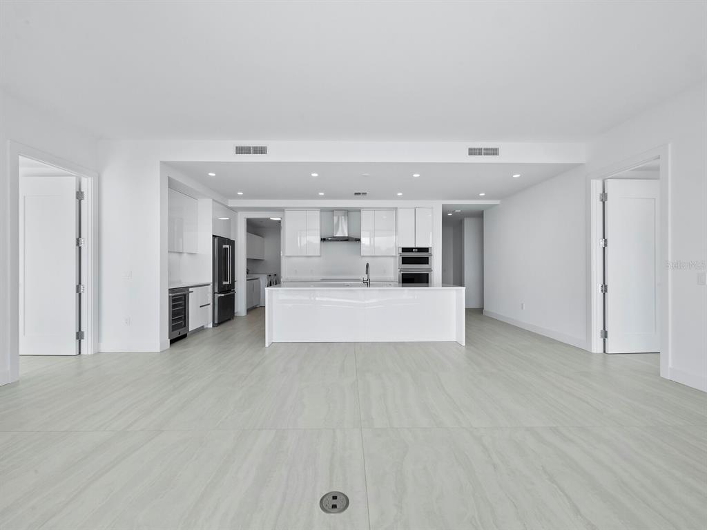 301 Quay Commons, Unit 1409 Sarasota, FL 34236 - Photo 5 of 45 a view of a kitchen with a sink and white cabinets