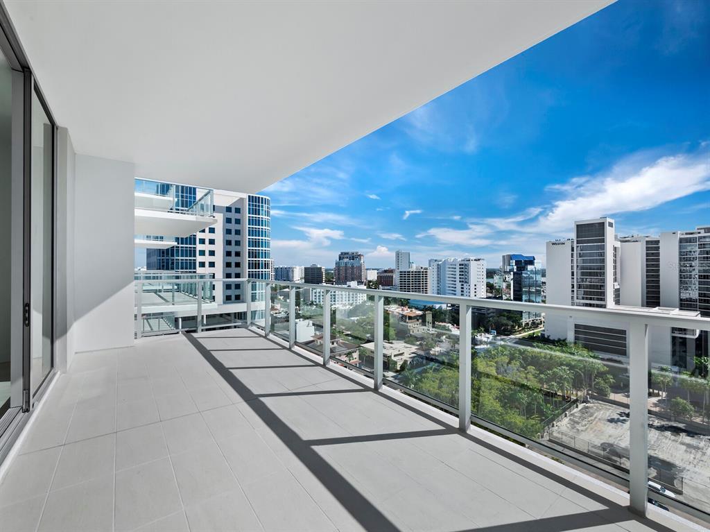 301 Quay Commons, Unit 1409 Sarasota, FL 34236 - Photo 8 of 45 a view of a patio with a table and chairs