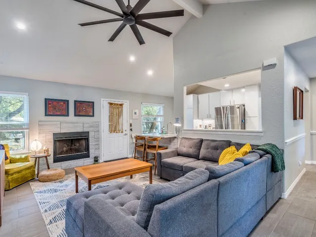 a living room with furniture fireplace and window