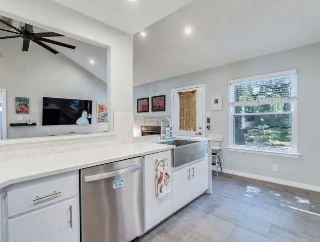 a kitchen with a sink and white cabinets