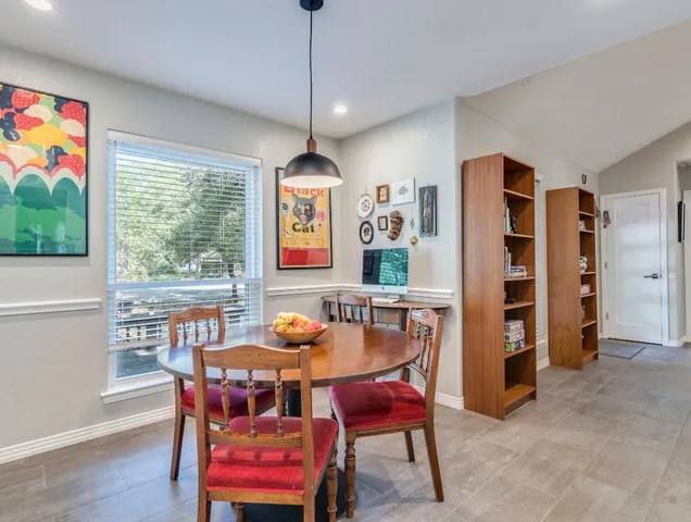 a dining room with furniture and window