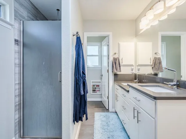 a spacious bathroom with a double vanity sink and a mirror