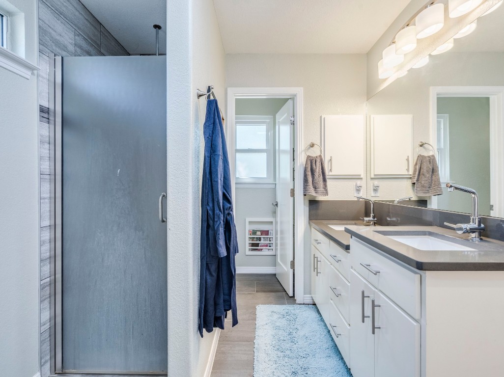 1008 Riviera Drive Cedar Park, TX 78613 - Photo 15 of 32 a spacious bathroom with a double vanity sink and a mirror