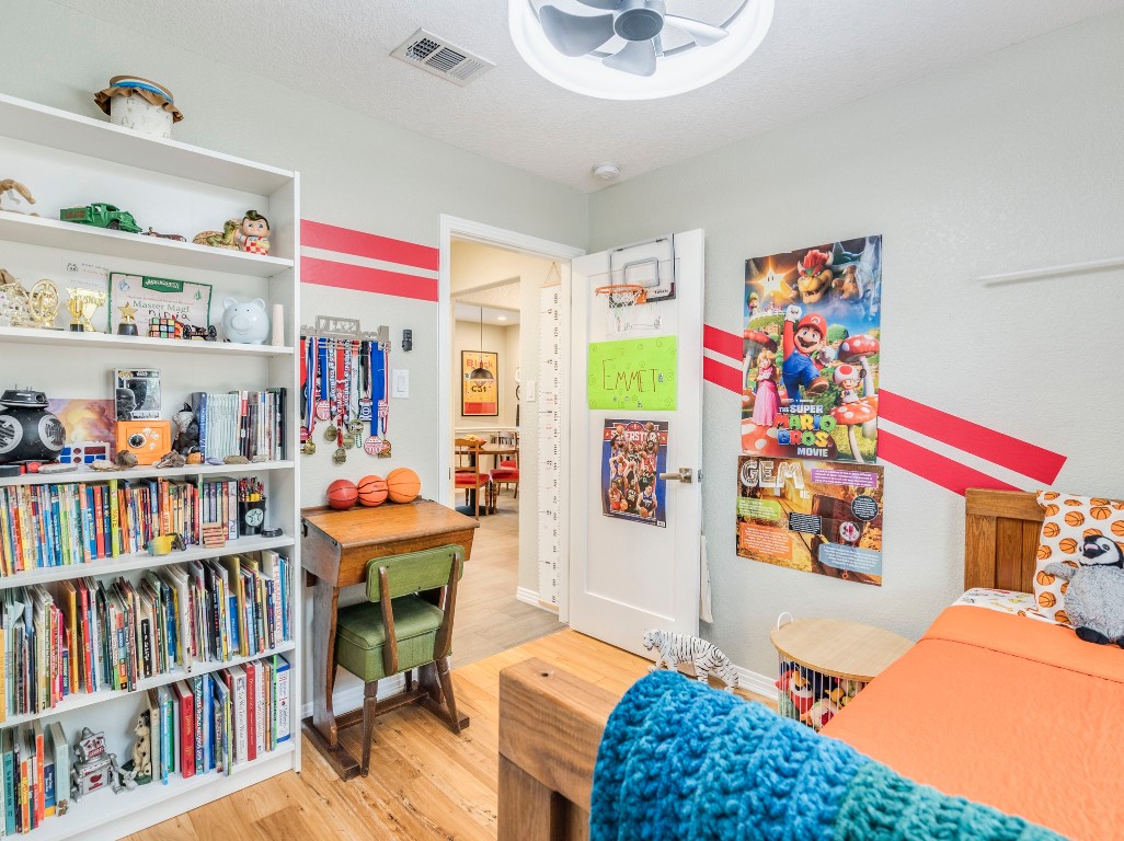 1008 Riviera Drive Cedar Park, TX 78613 - Photo 17 of 32 a room with furniture a rug toys and a book shelf