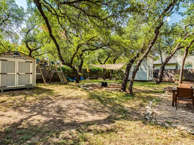 a view of a yard with swimming pool