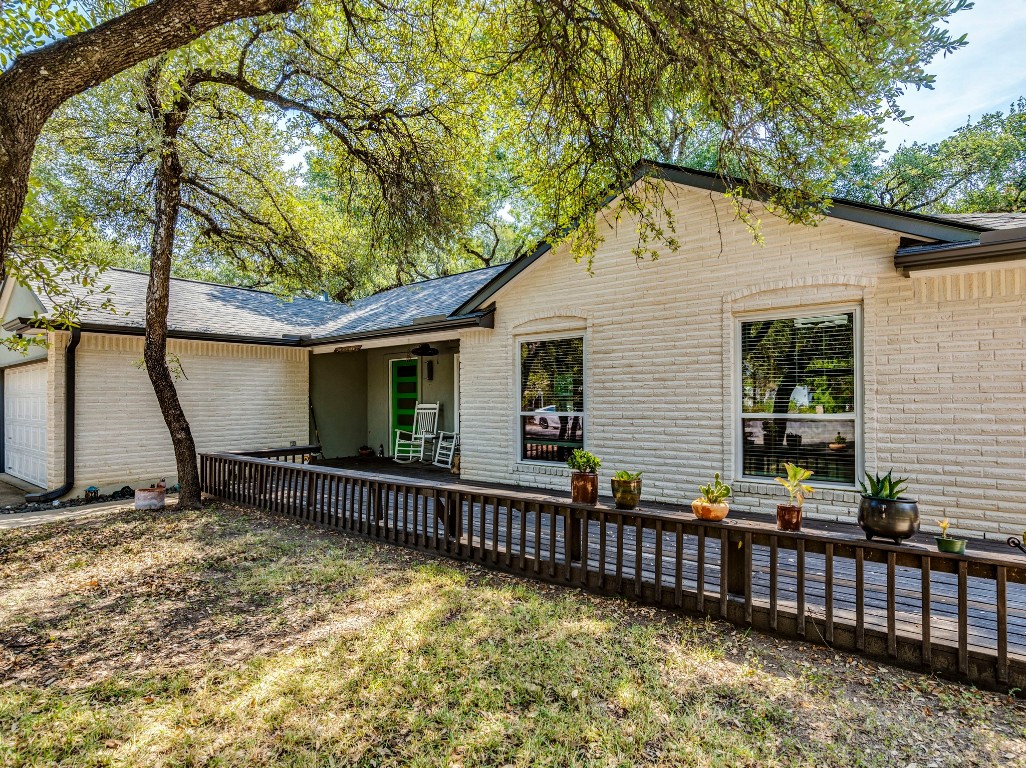 1008 Riviera Drive Cedar Park, TX 78613 - Photo 32 of 32 a view of a house with wooden fence and a large tree