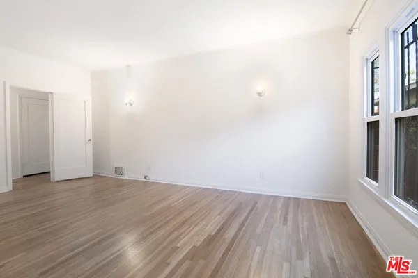 a view of a room with wooden floor