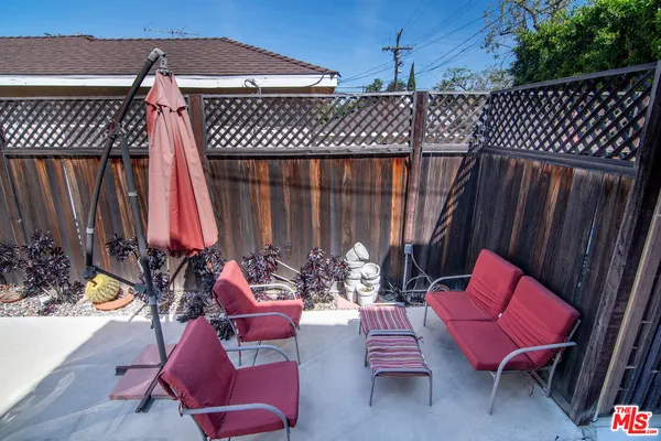 a view of a chairs and tables in the back yard of the house