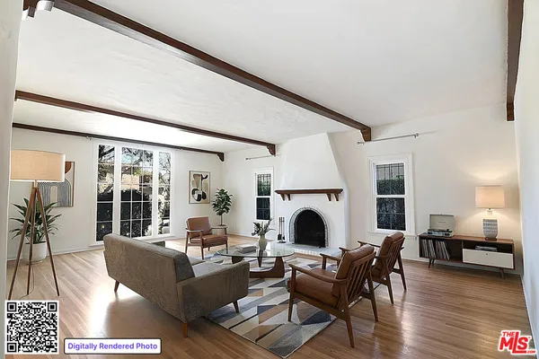 a living room with furniture large window and a fireplace