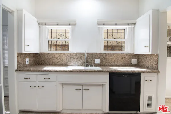 a sink with granite countertop a sink and cabinets