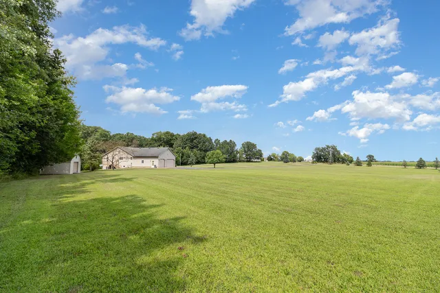 a view of a big yard with large trees