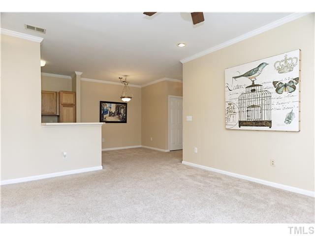 Enjoy an open design with raised breakfast bar and  dining room.  Newer carpet and paint. Notice... crown molding, ceiling fan and 9' ceiling.