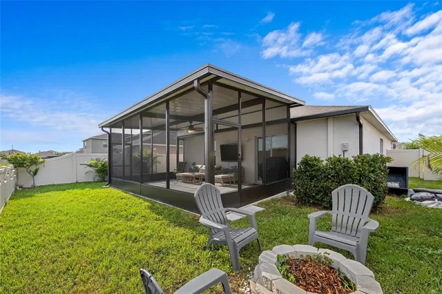 a view of a house with backyard and sitting area