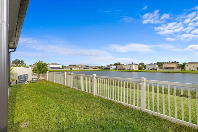 a view of a lake with a houses in the background