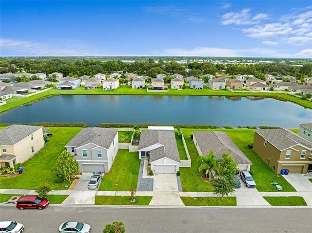 an aerial view of a house with a lake view