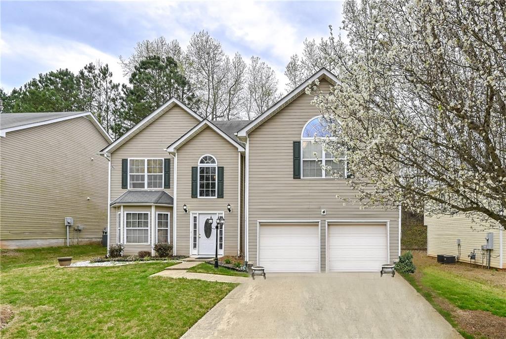 2035 Reflective Waters Road Villa Rica, GA 30180 - Photo 1 of 1 a front view of a house with a yard and garage