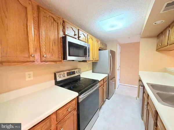 a kitchen that has a sink and a stove in it