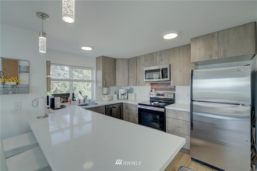 512 Mill Avenue South Renton, WA 98057 - Photo 5 of 19 a kitchen with granite countertop a refrigerator stove and sink
