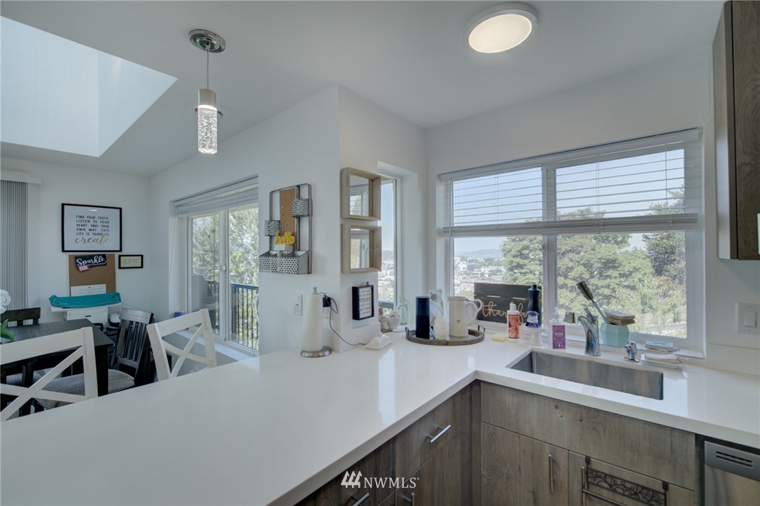 512 Mill Avenue South Renton, WA 98057 - Photo 7 of 19 a kitchen with a sink and large windows