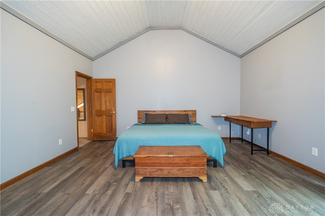10584 New Biddinger Road Harrison, OH 45030 - Photo 30 of 61 This spacious bedroom features a soaring vaulted ceiling and durable vinyl plank flooring.