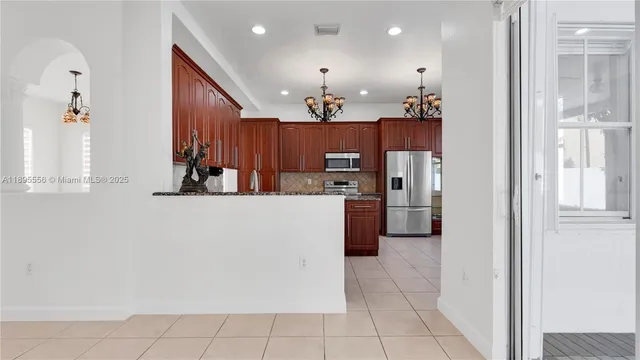 a kitchen with stainless steel appliances granite countertop a sink and a stove