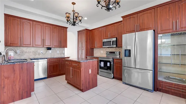 a kitchen with granite countertop a sink and a stove