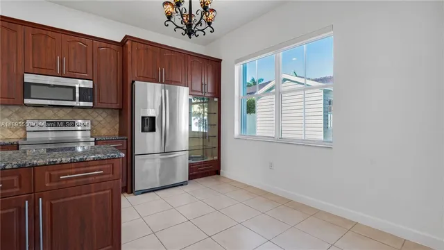 a bathroom with a granite countertop sink and a toilet