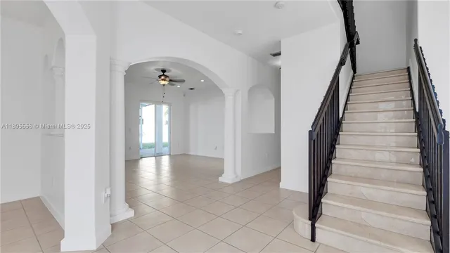 a view of entryway with wooden floor and stairs
