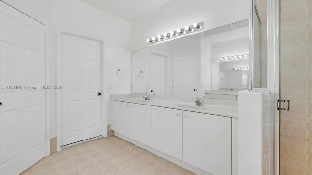 an empty room with a window and a ceiling fan