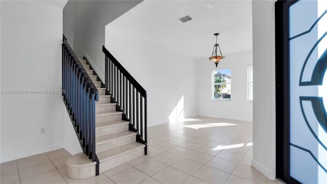 a view of a hallway with a window and stairs