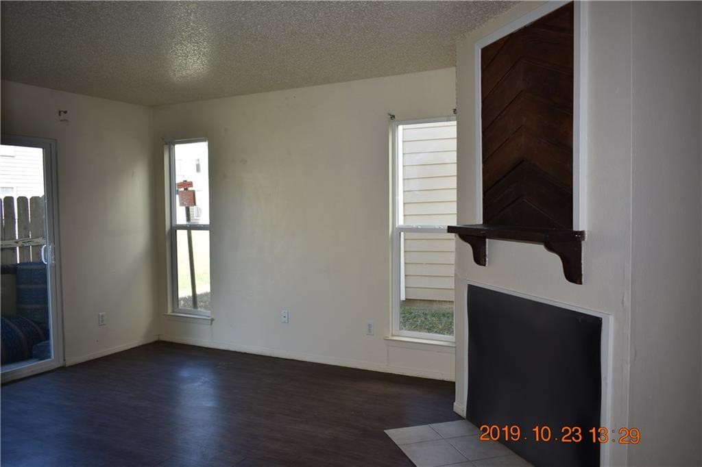 1908 West Loop, Unit A Austin, TX 78758 - Photo 7 of 13 an empty room with wooden floor and windows