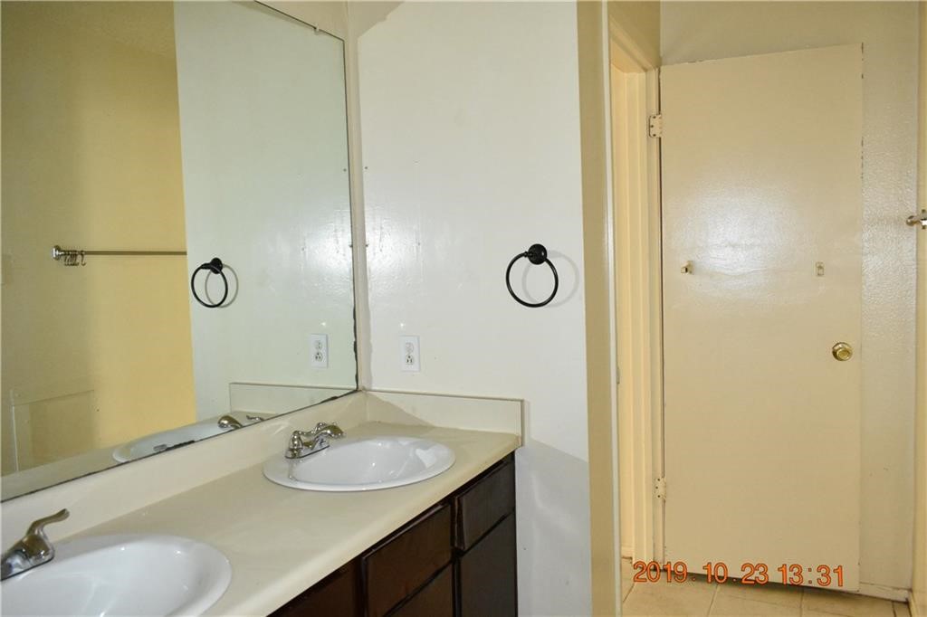 1908 West Loop, Unit A Austin, TX 78758 - Photo 9 of 13 a bathroom with a sink and a mirror